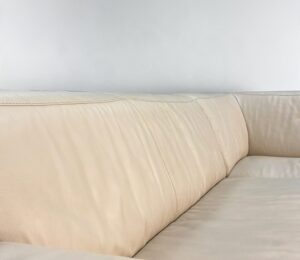 Corner Sofa Of light grey material with an electrical relaxation function